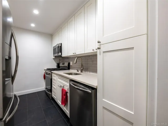 a utility room with cabinets washer and dryer