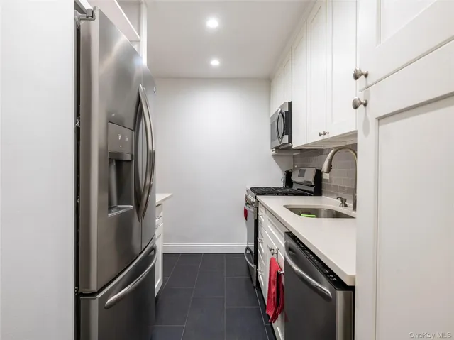 a kitchen with a refrigerator sink and stove