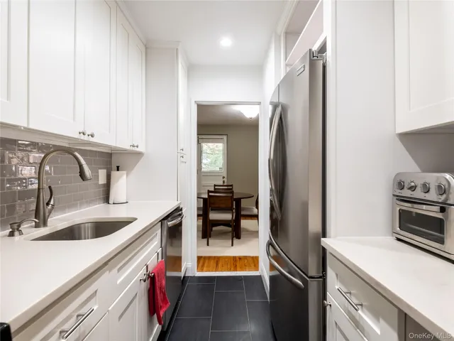 a kitchen with a sink and a refrigerator
