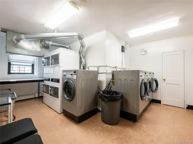 a utility room with sink dryer and washer