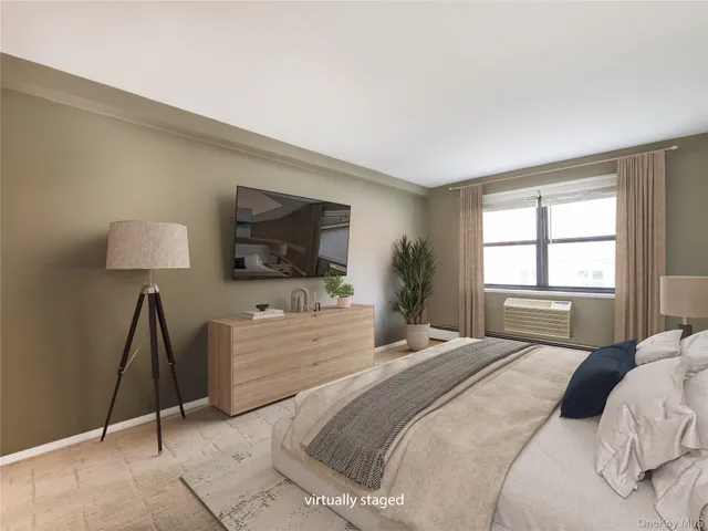 a bedroom with a bed and a flat screen television