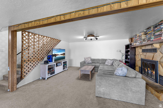 88 West 700 South Payson, UT 84651 - Photo 13 of 27 Carpeted living area with a textured ceiling and a fireplace