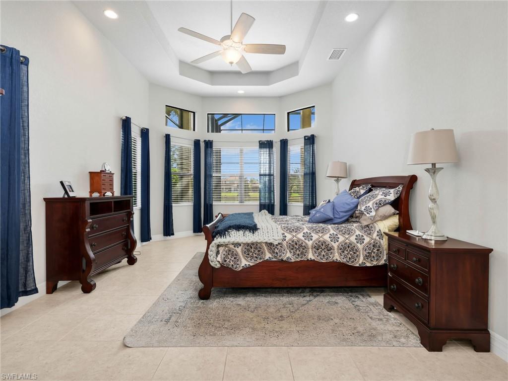 2756 Crystal Way Naples, FL 34119 - Photo 11 of 50 a bedroom with a bed and wooden floor