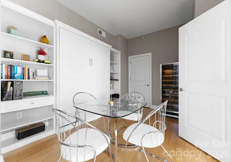 a dining room with furniture and wooden floor