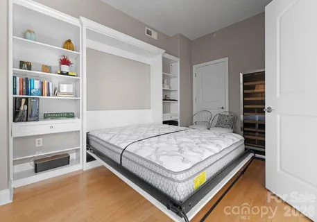 a bedroom with a bed and dresser