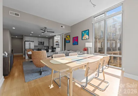 a view of a dining room with furniture and a large window