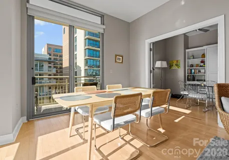 a dining room with furniture and wooden floor