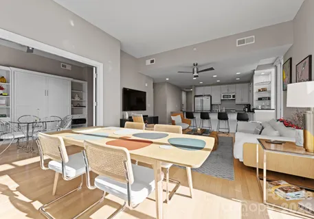 a view of a dining room kitchen with furniture and a flat screen tv