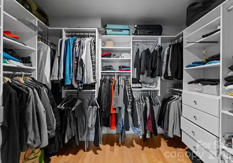 a view of walk in closet with clothes