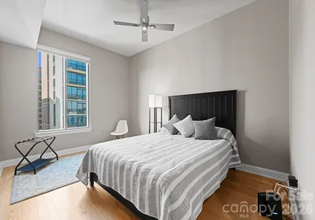 a bedroom with a bed and glass window