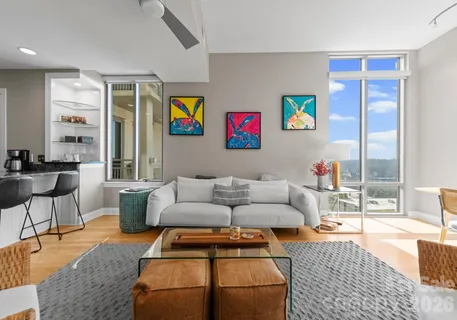 a living room with furniture a rug and a table