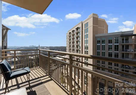 a view of a balcony with wooden floor and city view