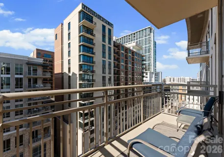 a view of a balcony with wooden floor and fence and a floor to ceiling window