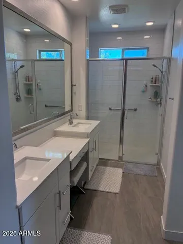 a bathroom with a sink vanity and a mirror