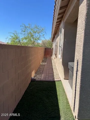 a living room with couches bookshelf and a large window with wooden floor