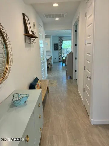 a hallway with a view of living room