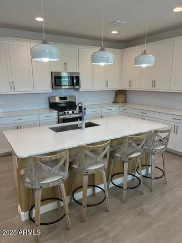 a living room with furniture a flat screen tv and a large window