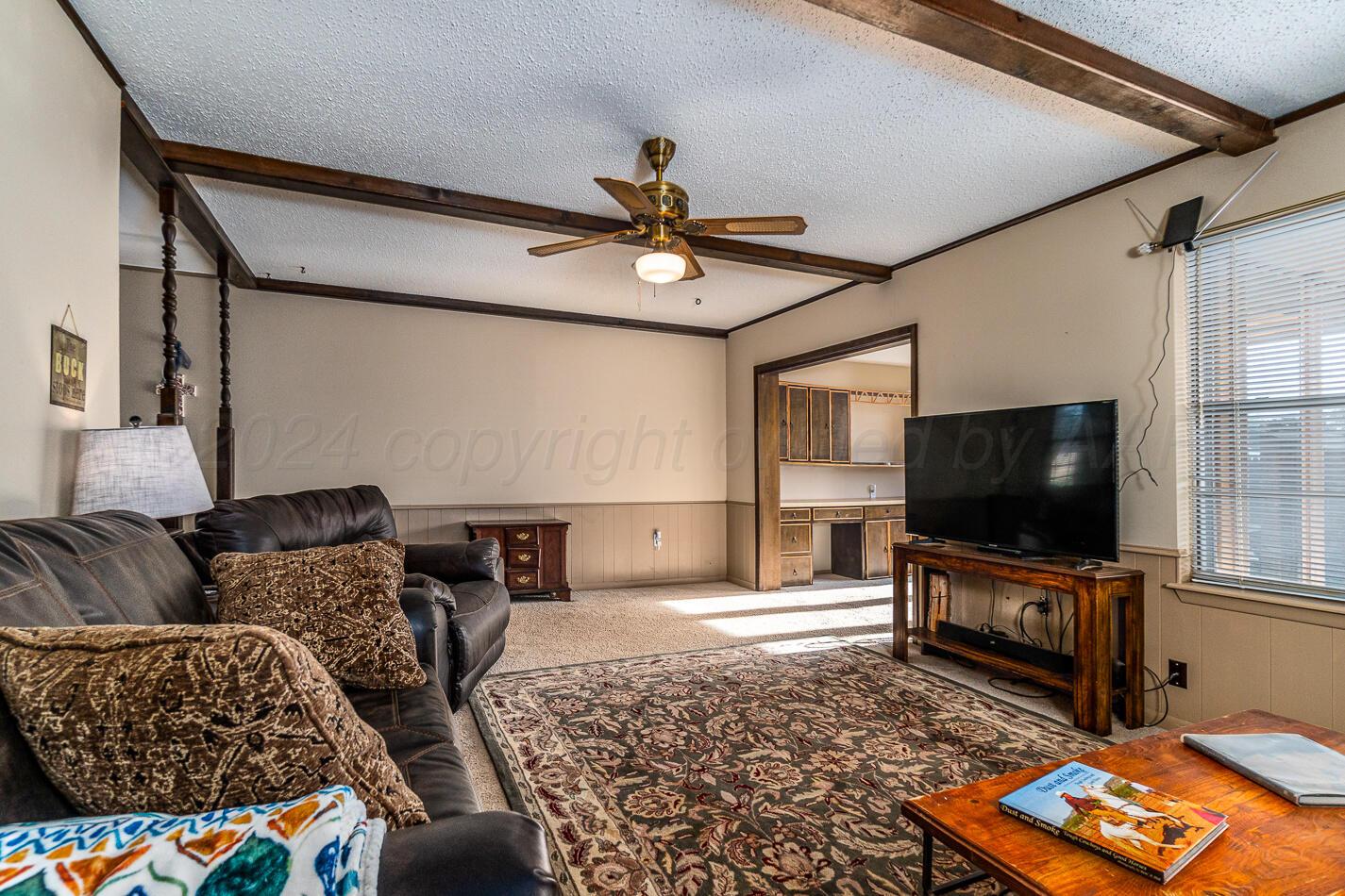 5135 Royce Drive Amarillo, TX 79110 - Photo 5 of 21 a living room with furniture and a flat screen tv