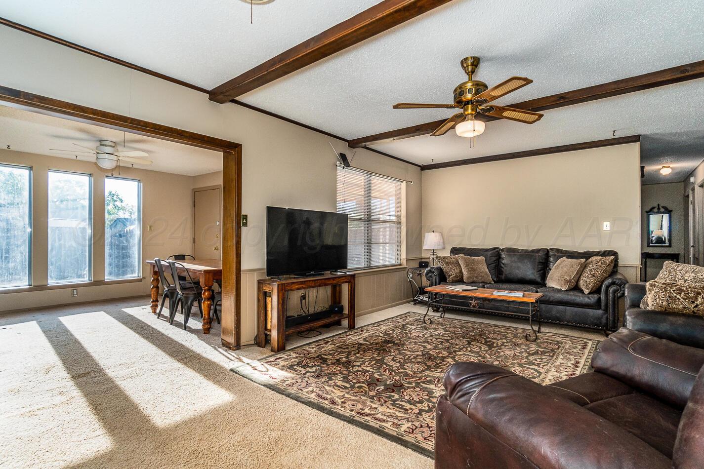 5135 Royce Drive Amarillo, TX 79110 - Photo 6 of 21 a living room with furniture and a flat screen tv