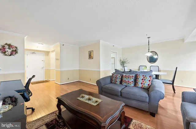 a living room with furniture a rug and a chandelier