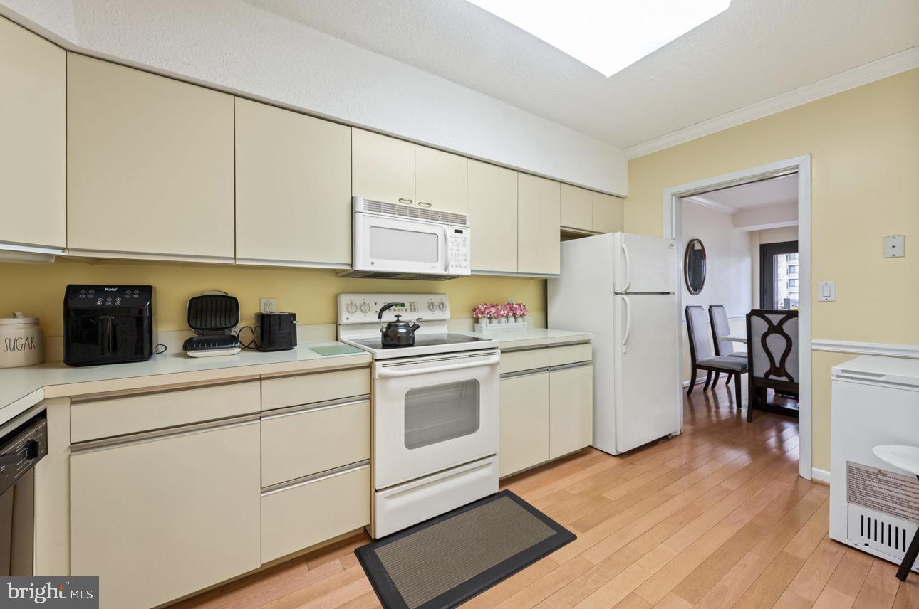 5501 Seminary Road, Unit 801S Falls Church, VA 22041 - Photo 15 of 32 a kitchen with white cabinets and white appliances
