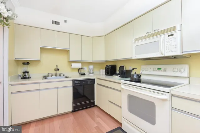 a kitchen with a sink cabinets and appliances