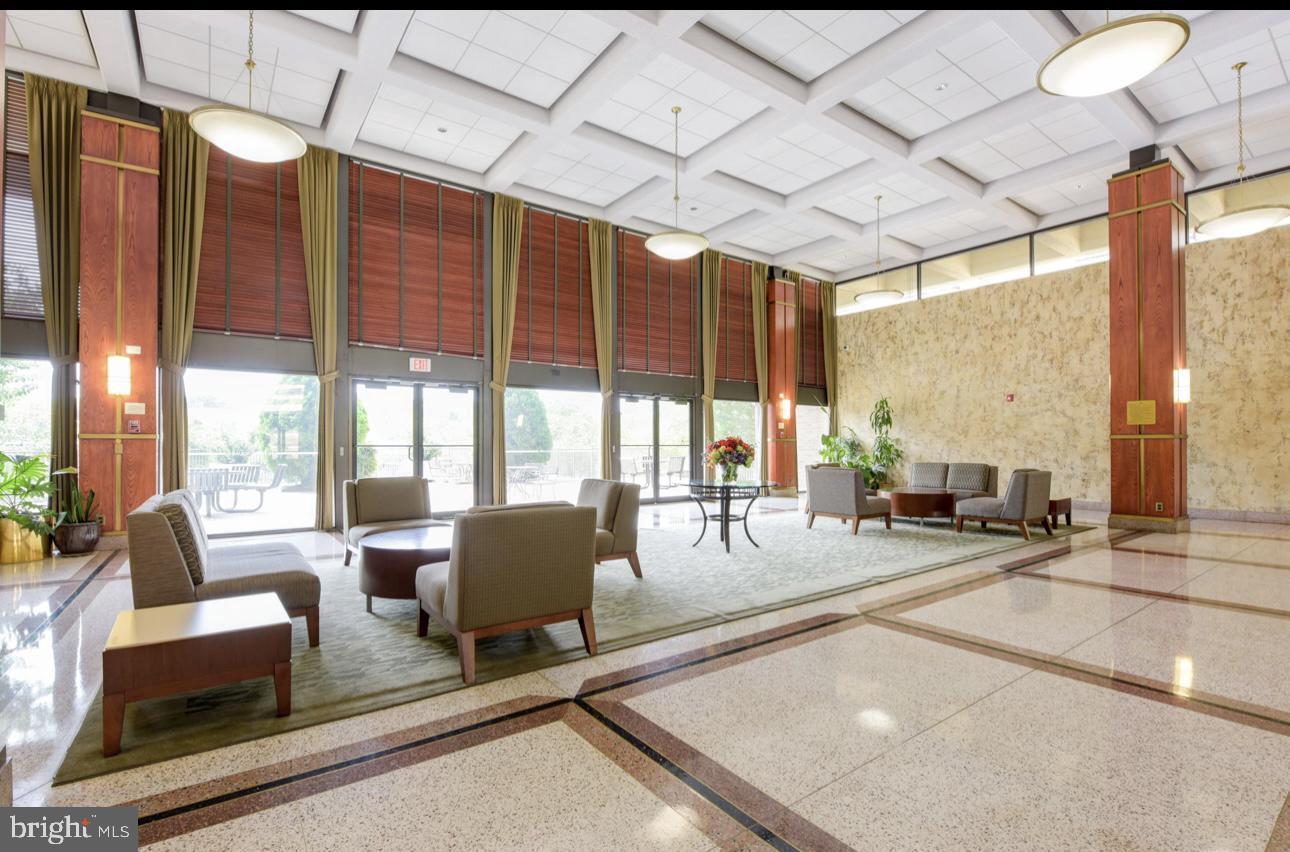 5501 Seminary Road, Unit 801S Falls Church, VA 22041 - Photo 27 of 32 a living room with patio furniture and floor to ceiling windows