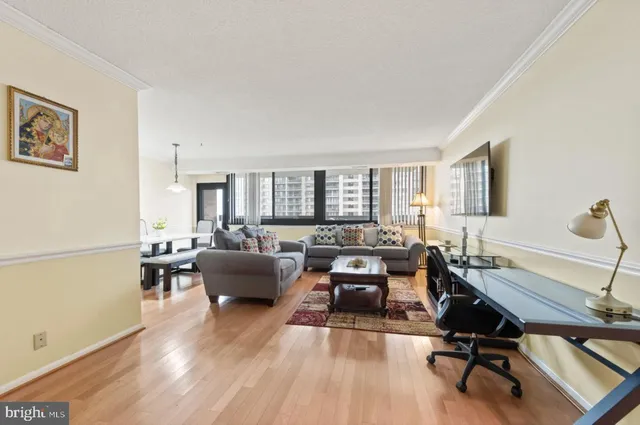 a living room with furniture and wooden floor