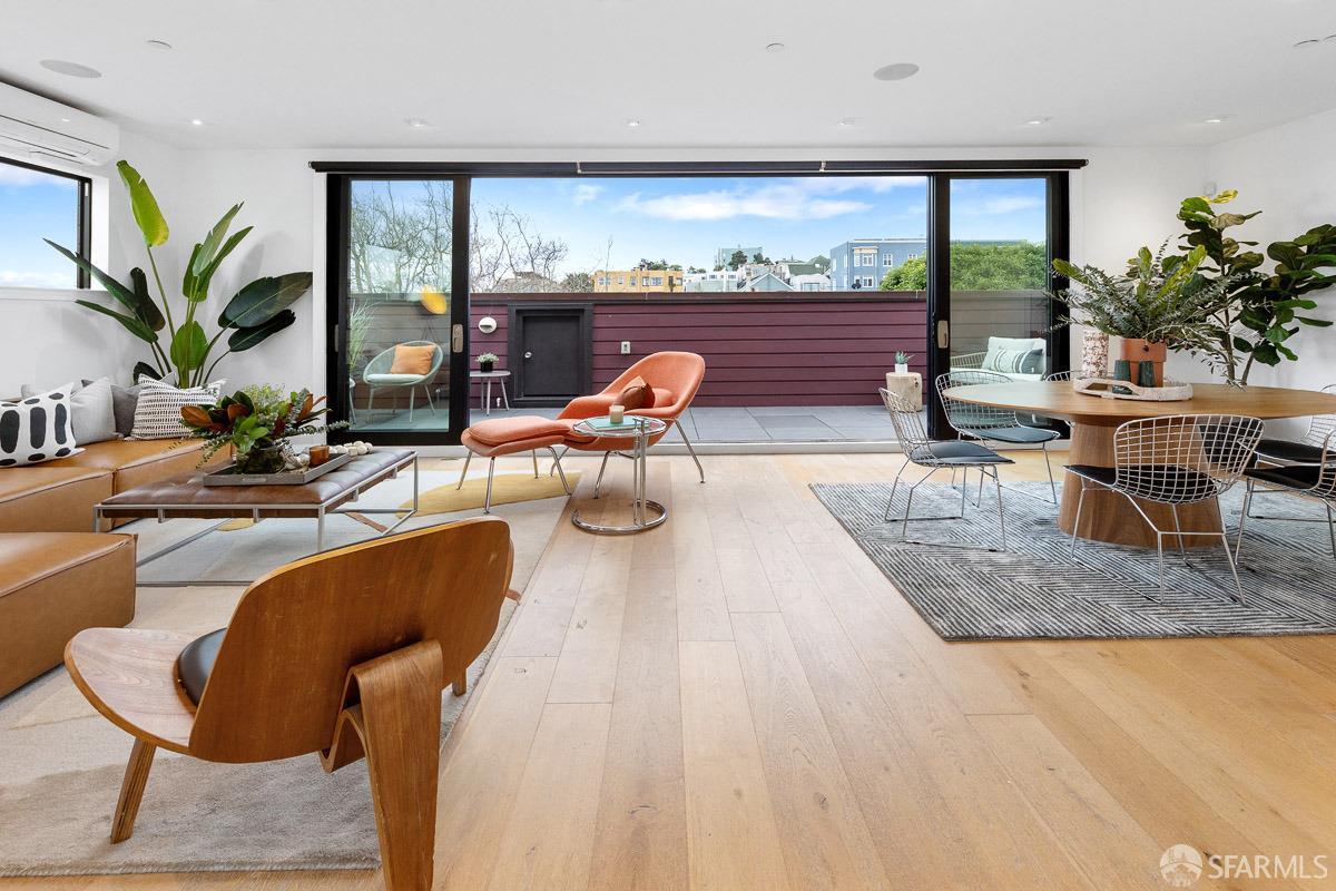 a living room with furniture a large window with outer view
