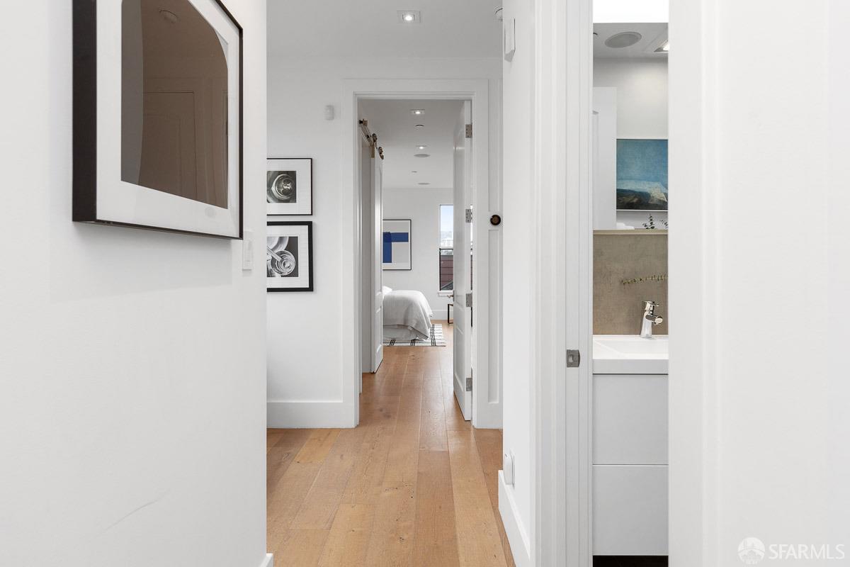564 Fell Street San Francisco, CA 94102 - Photo 18 of 82 a view of a hallway with wooden floor and a bathroom