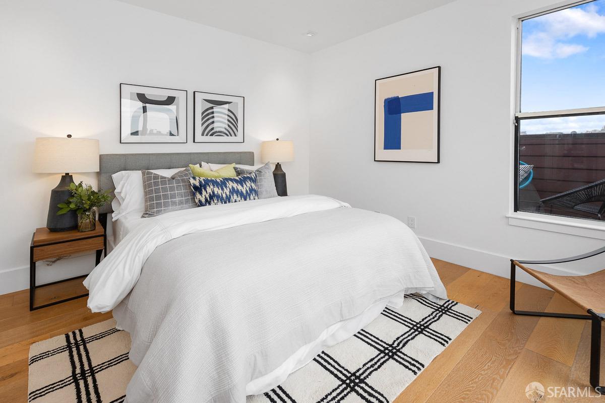 564 Fell Street San Francisco, CA 94102 - Photo 20 of 82 a bedroom with a bed and a lamp on dresser