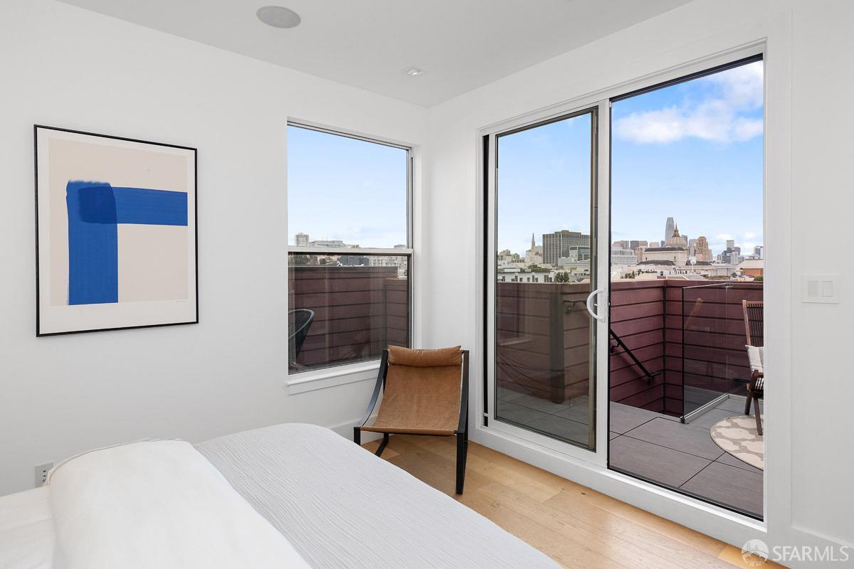 564 Fell Street San Francisco, CA 94102 - Photo 21 of 82 a bedroom with a bed and glass door