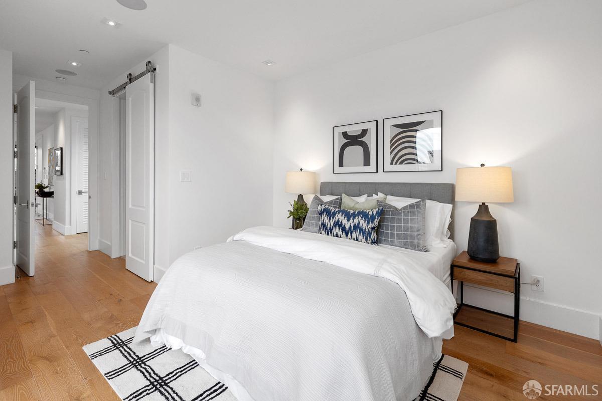 564 Fell Street San Francisco, CA 94102 - Photo 22 of 82 a bed room with a bed and a night stand