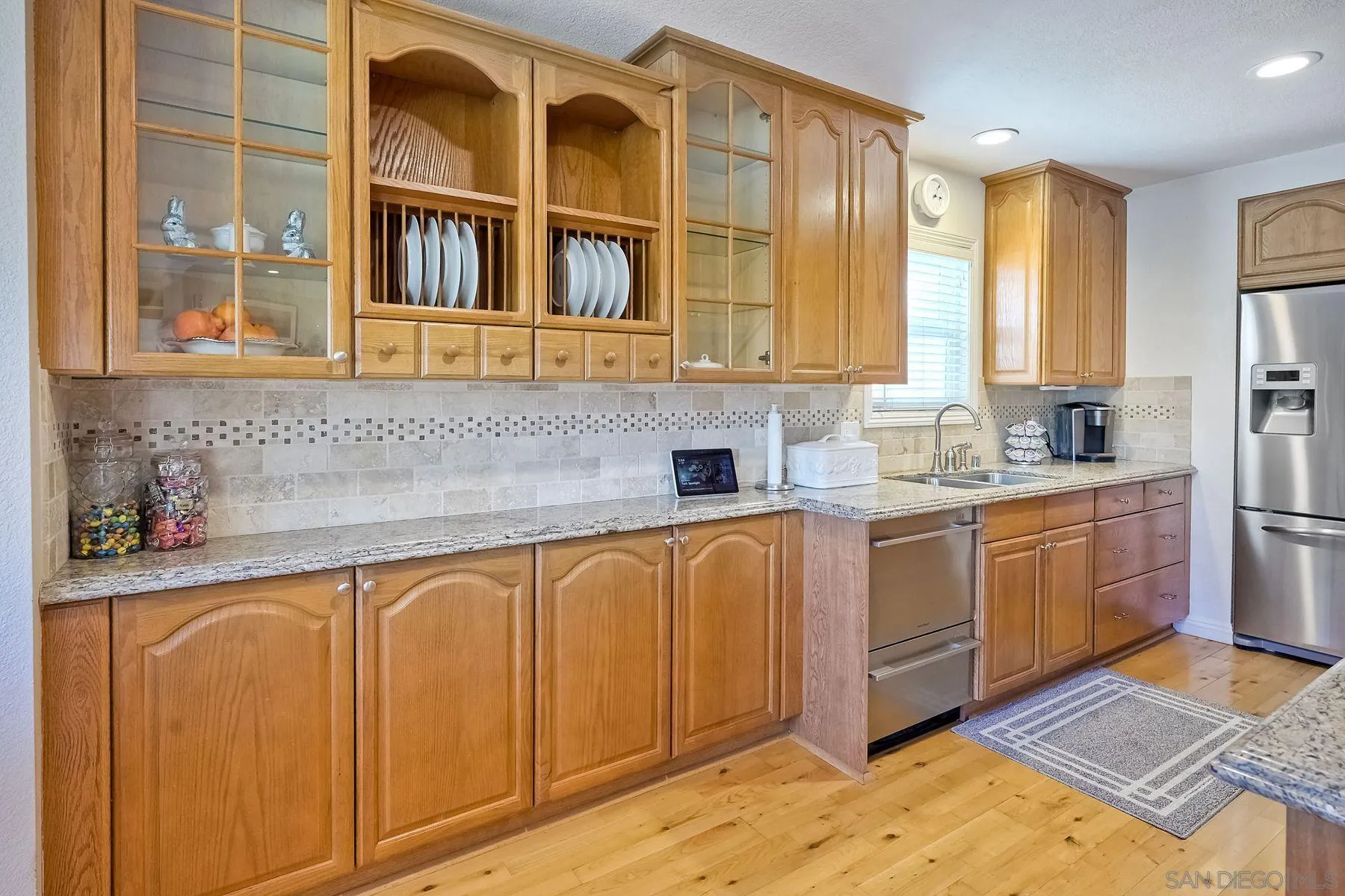 13821 Eisenhower Avenue Poway, CA 92064 - Photo 15 of 37 a kitchen with stainless steel appliances granite countertop a sink and cabinets
