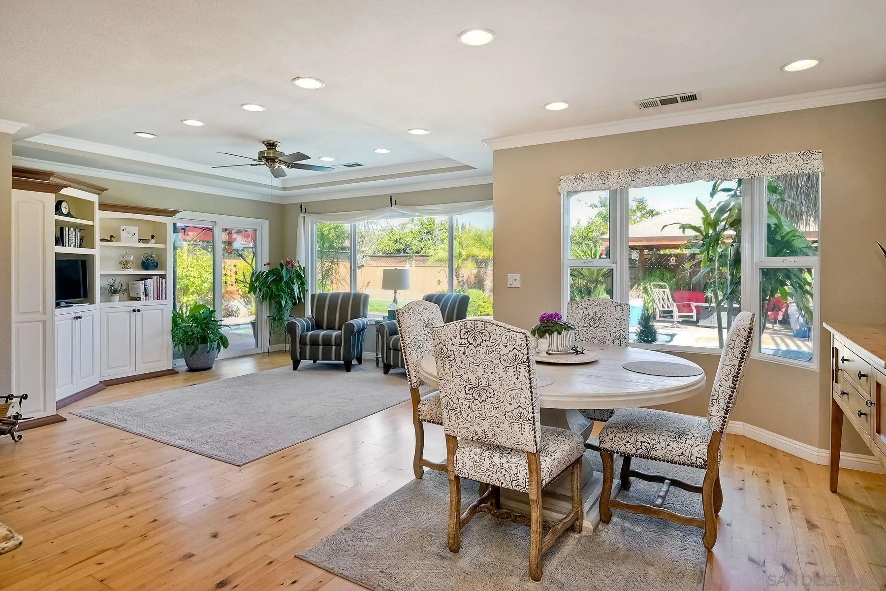 13821 Eisenhower Avenue Poway, CA 92064 - Photo 17 of 37 a view of a dining room with furniture large windows and wooden floor