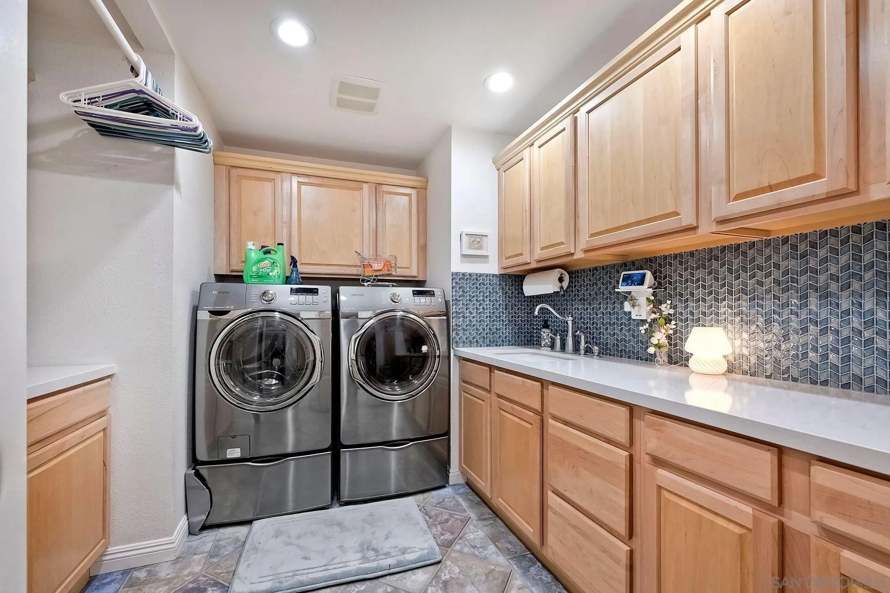 13821 Eisenhower Avenue Poway, CA 92064 - Photo 9 of 37 a kitchen with granite countertop a sink a stove top oven and cabinets