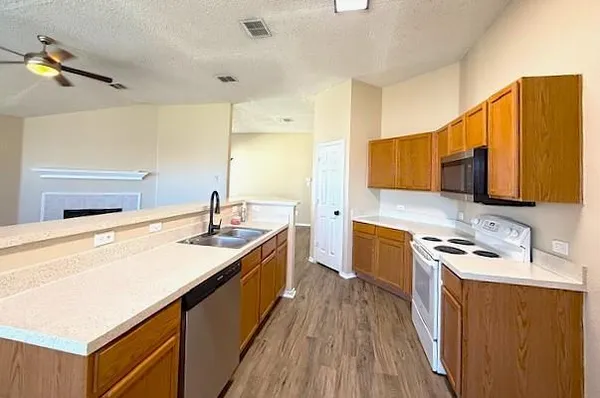a kitchen with a sink stove and microwave