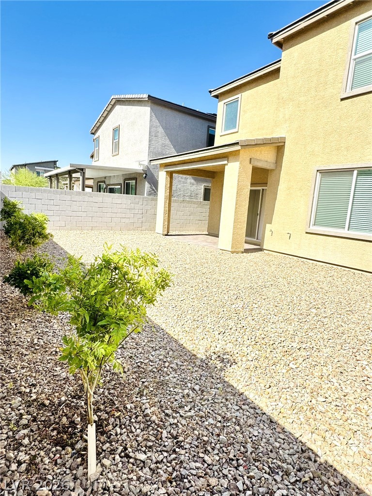 4457 Sawyer Ridge Street Las Vegas, NV 89147 - Photo 31 of 32 A spacious backyard awaits, featuring a covered patio ideal for outdoor relaxation.
