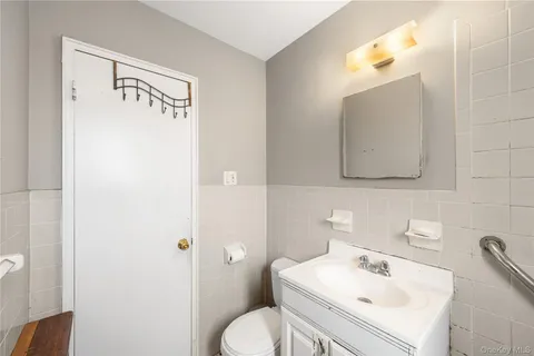 a bathroom with a sink a toilet and mirror
