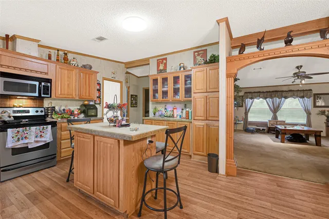 a kitchen with stainless steel appliances granite countertop a stove and a refrigerator