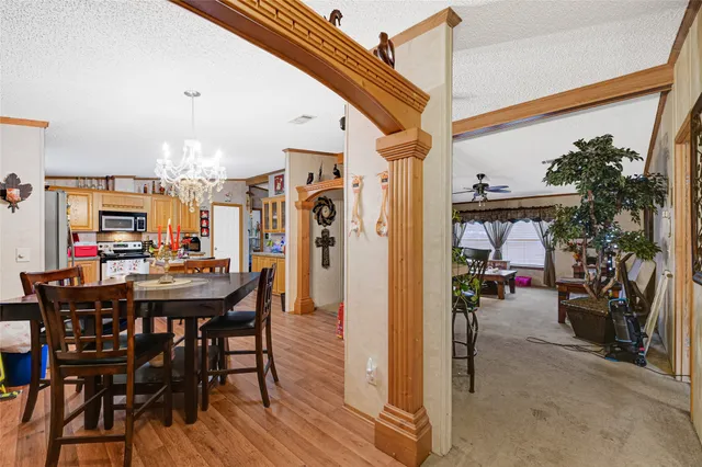 a view of a dining room with furniture and a chandelier