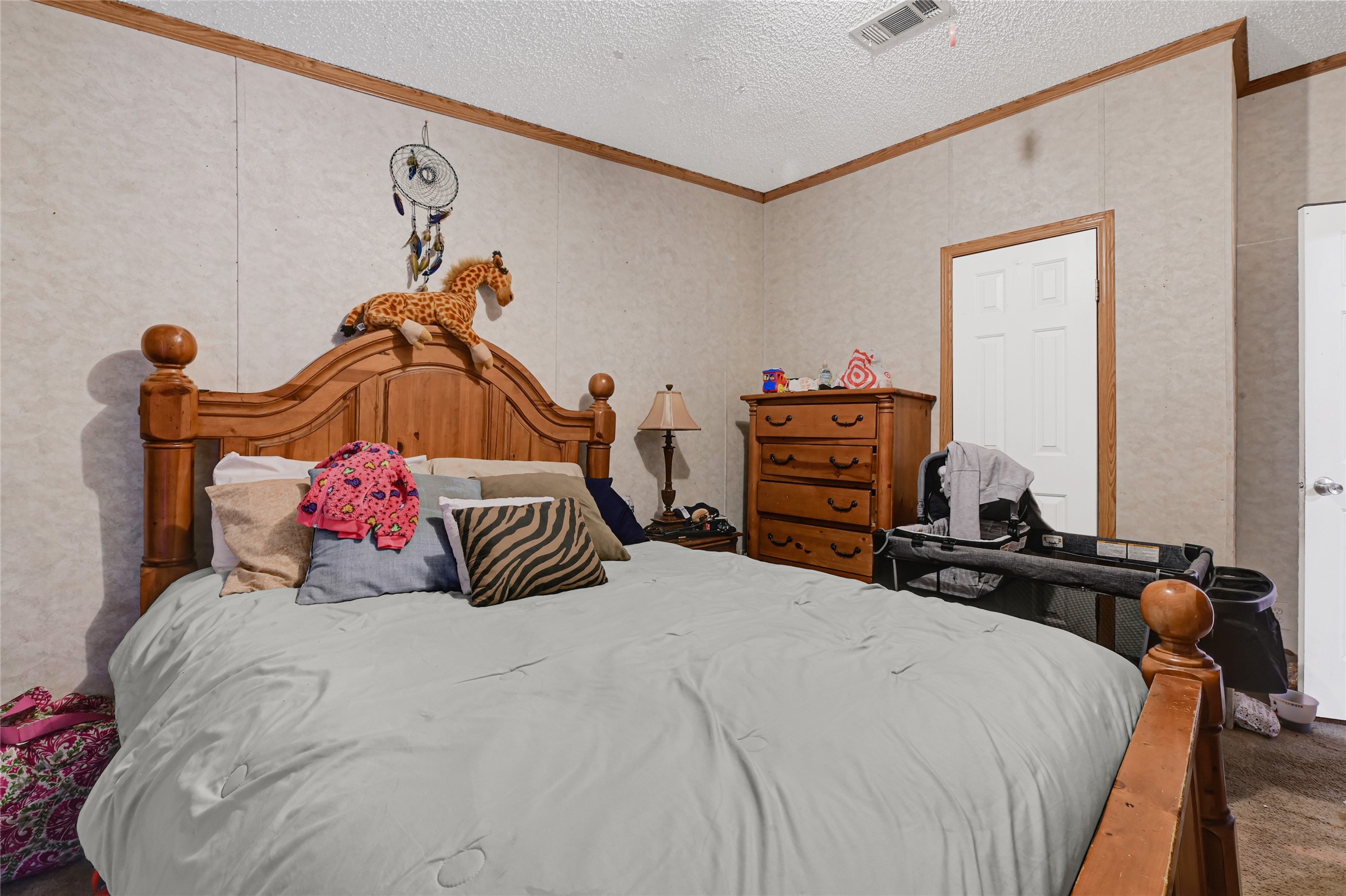 17106 Pickering Road Conroe, TX 77302 - Photo 25 of 50 a bedroom with a bed and a chandelier