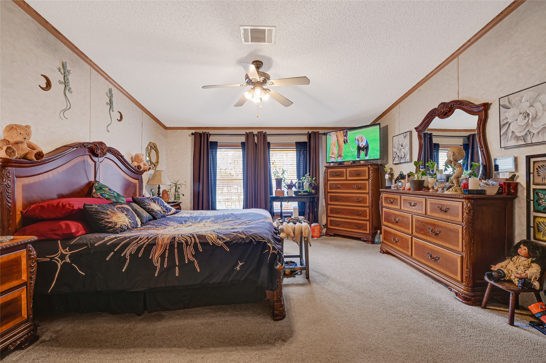 17106 Pickering Road Conroe, TX 77302 - Photo 36 of 50 a bedroom with a bed and a chandelier