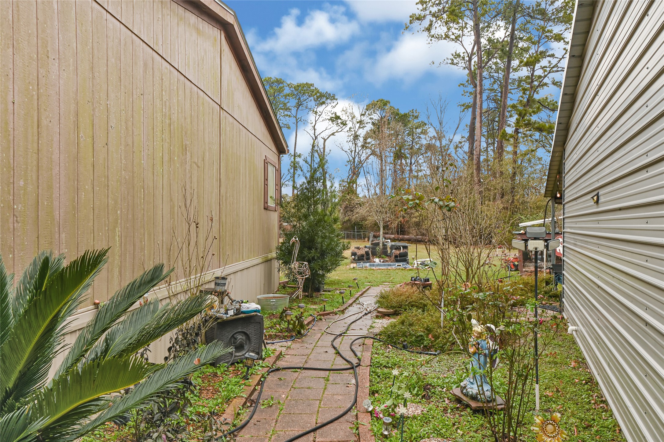 17106 Pickering Road Conroe, TX 77302 - Photo 44 of 50 a view of a yard with plants and wooden fence