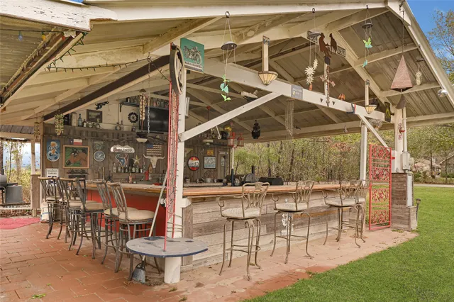 a view of a patio with a table and chairs