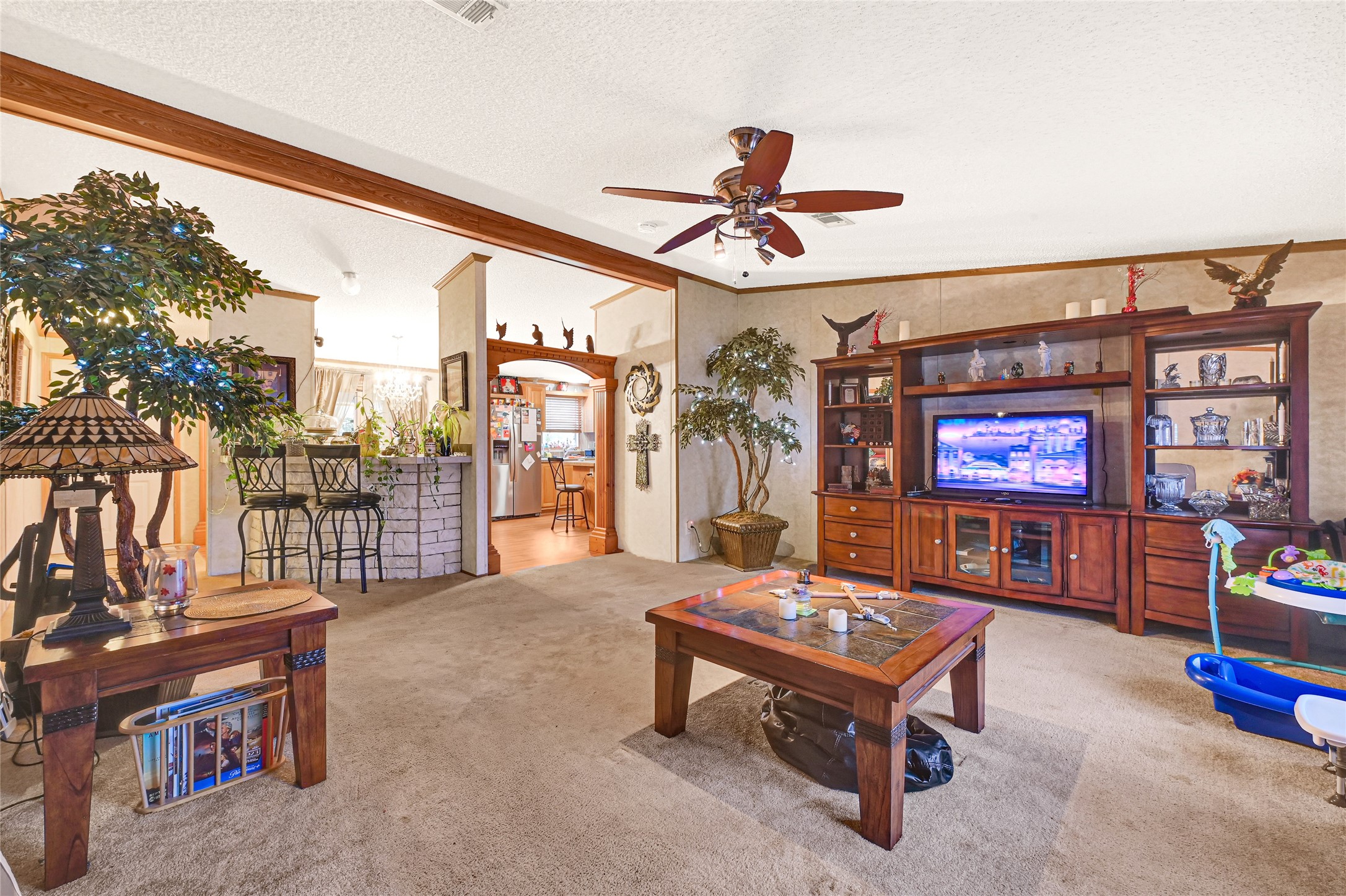 17106 Pickering Road Conroe, TX 77302 - Photo 9 of 50 a living room with furniture a rug and a chandelier