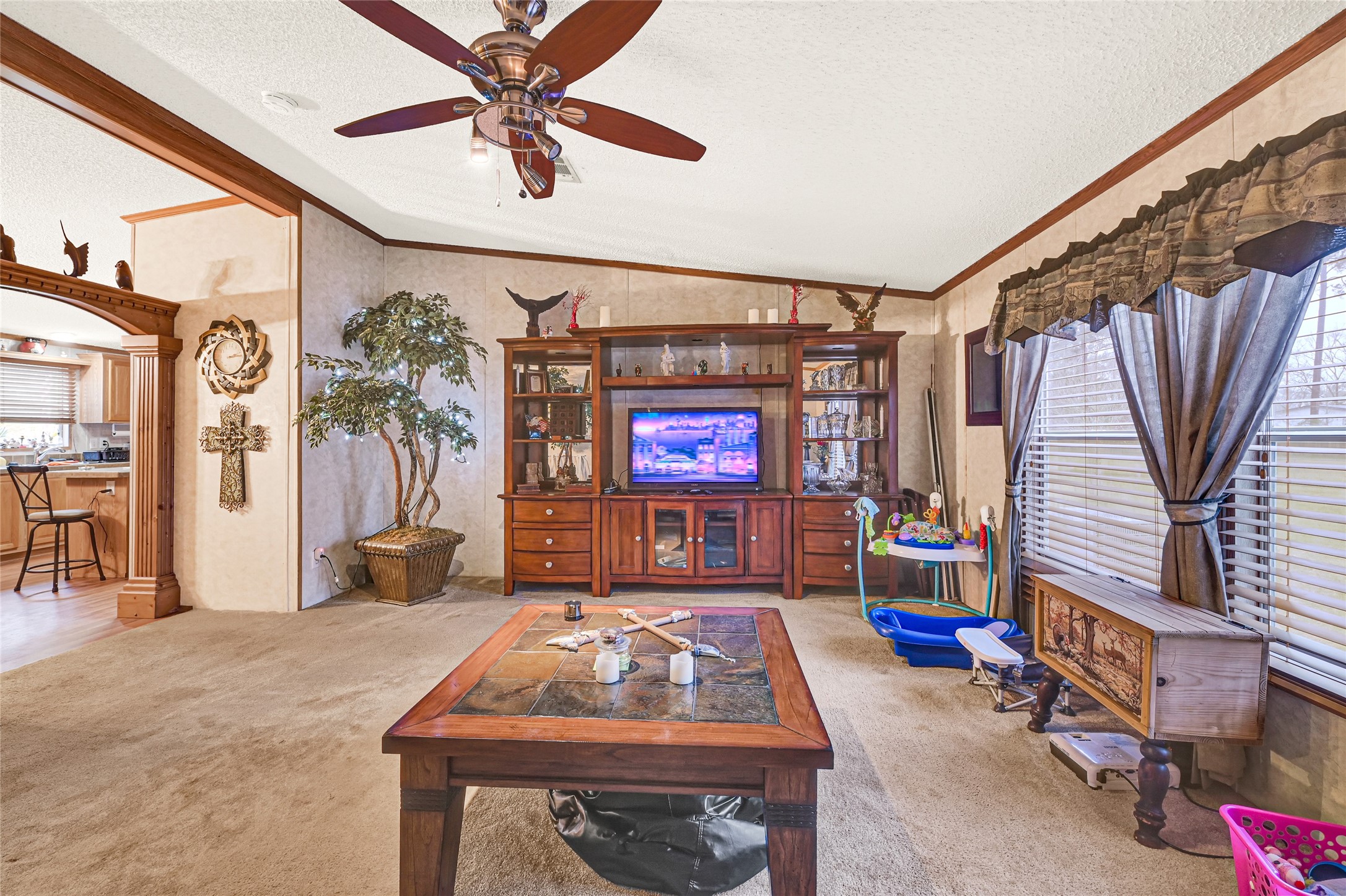17106 Pickering Road Conroe, TX 77302 - Photo 10 of 50 a living room with blue lights with furniture and a flat screen tv