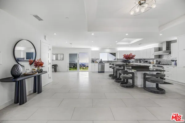 a kitchen with stainless steel appliances a sink a stove and cabinets