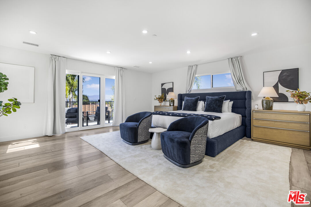 18202 Rancho Street Tarzana, CA 91356 - Photo 22 of 33 a bedroom with furniture and wooden floor