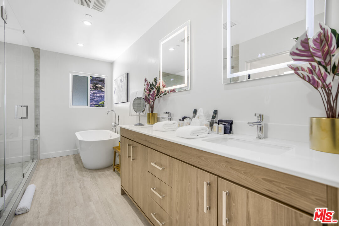 18202 Rancho Street Tarzana, CA 91356 - Photo 25 of 33 a spacious bathroom with a granite countertop sink a toilet and a mirror